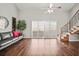 Spacious living room with hardwood floors, ceiling fan, and stairs leading to the second floor at 2581 Countryside Blvd # 2309, Clearwater, FL 33761