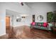 Open-concept living area boasts hardwood floors, sofa, and pass-through to kitchen at 2581 Countryside Blvd # 2309, Clearwater, FL 33761