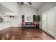 Living room features hardwood floors, neutral walls, and a decorative chandelier at 2581 Countryside Blvd # 2309, Clearwater, FL 33761