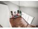 Living room with hardwood floors, neutral walls, ceiling fan, and stairs leading up to a loft at 2581 Countryside Blvd # 2309, Clearwater, FL 33761