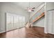 Bright living room features hardwood floors, plantation shutters, ceiling fan and a staircase at 2581 Countryside Blvd # 2309, Clearwater, FL 33761