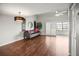Inviting living room boasting hardwood floors, a stylish chandelier, and sliding glass doors to a balcony at 2581 Countryside Blvd # 2309, Clearwater, FL 33761
