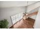 Upper view of living room with hardwood floors, shutters and staircase at 2581 Countryside Blvd # 2309, Clearwater, FL 33761