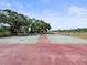 Exterior tennis courts surrounded by mature trees at 2581 Countryside Blvd # 2309, Clearwater, FL 33761