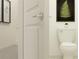 Powder room featuring a white toilet, modern artwork, and stylish decor at 2724 Bryce Ravine Ave, Plant City, FL 33563