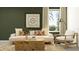 Inviting living room with comfortable seating, stylish artwork, and a view of lush greenery outside at 2724 Bryce Ravine Ave, Plant City, FL 33563