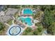 Aerial view of a community pool, splashpad, and lounge areas at a beautiful resort at 27440 Cedar Park Ct, Wesley Chapel, FL 33544