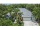 An aerial view of the home showcasing its roof, driveway, landscaping and three car garage at 27440 Cedar Park Ct, Wesley Chapel, FL 33544