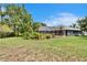 Lovely backyard with mature trees and landscaping, pool and screened-in lanai at 27440 Cedar Park Ct, Wesley Chapel, FL 33544