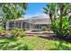 Beautiful home backyard with mature trees and landscaping, pool and screened-in patio at 27440 Cedar Park Ct, Wesley Chapel, FL 33544