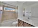 Well-lit bathroom with modern fixtures, tiled walls, and a shower-tub combo at 27440 Cedar Park Ct, Wesley Chapel, FL 33544