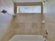 Clean bathroom featuring tiled walls, shower head, and a bathtub at 27440 Cedar Park Ct, Wesley Chapel, FL 33544