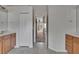 Bathroom with double sinks, neutral tile flooring, and hall access at 27440 Cedar Park Ct, Wesley Chapel, FL 33544
