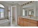 Bathroom featuring a walk in shower, soaking tub, and wooden cabinetry at 27440 Cedar Park Ct, Wesley Chapel, FL 33544