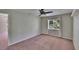 Spacious bedroom featuring neutral walls, ceiling fan, and a window providing ample natural light at 27440 Cedar Park Ct, Wesley Chapel, FL 33544
