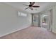 Bedroom featuring a ceiling fan, neutral walls, carpet flooring, and access to an outdoor space at 27440 Cedar Park Ct, Wesley Chapel, FL 33544