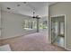 Bedroom features carpet, a ceiling fan, windows with views of the backyard, and an en-suite bathroom at 27440 Cedar Park Ct, Wesley Chapel, FL 33544