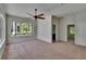 Bedroom with neutral walls and carpet, ceiling fan, and access to bathroom and another room at 27440 Cedar Park Ct, Wesley Chapel, FL 33544