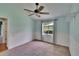 Bright bedroom with unique blue accent wall, wainscoting, and a ceiling fan at 27440 Cedar Park Ct, Wesley Chapel, FL 33544
