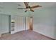 Bright bedroom with unique blue accent wall, wainscoting, and closet at 27440 Cedar Park Ct, Wesley Chapel, FL 33544