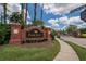 Brick entrance sign for Pinecrest neighborhood with lush landscaping and neighborhood gate at 27440 Cedar Park Ct, Wesley Chapel, FL 33544