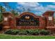 Community entrance sign for The Club at Seven Oaks with brick columns and landscaping at 27440 Cedar Park Ct, Wesley Chapel, FL 33544