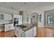 Kitchen with stainless steel appliances, granite countertops, and an island cooktop, with an eat in space at 27440 Cedar Park Ct, Wesley Chapel, FL 33544