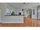 Open kitchen with granite countertops, stainless steel appliances, and hardwood floors at 27440 Cedar Park Ct, Wesley Chapel, FL 33544