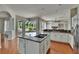 Updated kitchen features stainless steel appliances, granite countertops, and an island cooktop overlooking the backyard at 27440 Cedar Park Ct, Wesley Chapel, FL 33544