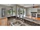 Kitchen with stainless steel sink, granite countertops, and an island cooktop, overlooking a pool at 27440 Cedar Park Ct, Wesley Chapel, FL 33544