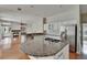 Bright kitchen with stainless steel appliances, granite countertops, and an island with a cooktop at 27440 Cedar Park Ct, Wesley Chapel, FL 33544
