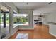 Bright living room with hardwood floors and a view of the pool and backyard at 27440 Cedar Park Ct, Wesley Chapel, FL 33544