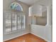 Bright corner living area features hardwood floors, white shutters, and modern lighting at 27440 Cedar Park Ct, Wesley Chapel, FL 33544