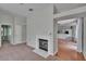 Bright living room with hardwood floors, fireplace, and open layout with access to kitchen at 27440 Cedar Park Ct, Wesley Chapel, FL 33544