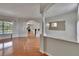 Spacious living room boasts hardwood floors, columns, and view to the backyard pool at 27440 Cedar Park Ct, Wesley Chapel, FL 33544