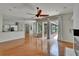 Open floor plan with hardwood flooring seamlessly connects the living room and kitchen at 27440 Cedar Park Ct, Wesley Chapel, FL 33544
