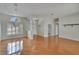 Inviting living room features hardwood floors, arched windows and access to other rooms at 27440 Cedar Park Ct, Wesley Chapel, FL 33544
