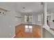 Bright living room features gleaming hardwood floors and stylish architectural columns at 27440 Cedar Park Ct, Wesley Chapel, FL 33544