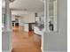 Open concept living space with stainless steel appliances, hardwood flooring, and two decorative columns at 27440 Cedar Park Ct, Wesley Chapel, FL 33544