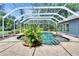 Beautiful screened-in pool with mature landscaping offering a private backyard oasis at 27440 Cedar Park Ct, Wesley Chapel, FL 33544