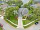 Beautiful aerial view of the landscaped home, circular driveway and two-car garage at 3000 Naughton Way, Tarpon Springs, FL 34688