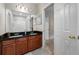 Bathroom featuring double sinks, granite countertops, and a shower with tile surround at 3000 Naughton Way, Tarpon Springs, FL 34688