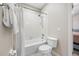 Bright bathroom with a shower-tub combo and white fixtures at 3000 Naughton Way, Tarpon Springs, FL 34688