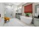 This bright and airy bathroom includes a walk-in shower, stand-alone tub, and double vanity at 3000 Naughton Way, Tarpon Springs, FL 34688