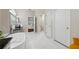 Bright bathroom with stand-alone tub, tiled floors, and access to the bedroom at 3000 Naughton Way, Tarpon Springs, FL 34688