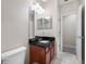 Bathroom featuring a vanity, toilet, and view of adjacent room at 3000 Naughton Way, Tarpon Springs, FL 34688