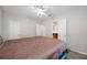 Bedroom with neutral walls, carpet flooring, ceiling fan, and connecting bathroom at 3000 Naughton Way, Tarpon Springs, FL 34688