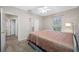 Bedroom with neutral walls, carpet flooring, window, ceiling fan, and connecting door at 3000 Naughton Way, Tarpon Springs, FL 34688