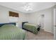 Bright bedroom with ceiling fan, two twin beds, and soft carpet flooring at 3000 Naughton Way, Tarpon Springs, FL 34688
