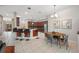 Spacious dining area featuring a breakfast bar, stainless appliances, and access to the outdoor living space at 3000 Naughton Way, Tarpon Springs, FL 34688